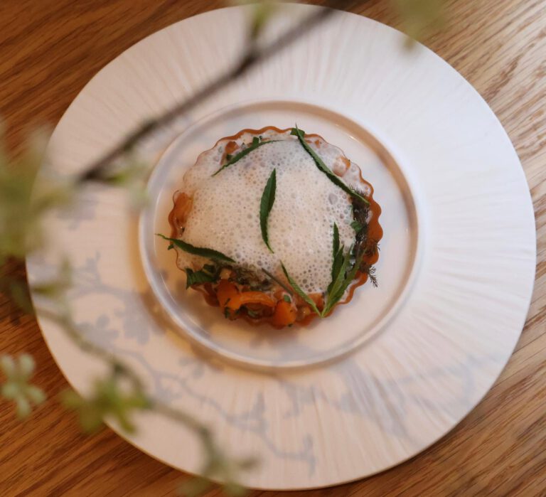 A seasonal SOMM dish on a white plate